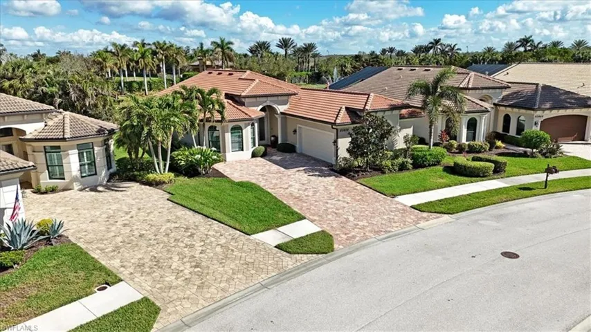 Mediterranean / spanish-style house featuring a front yard and a garage