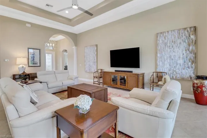 Tiled living room featuring ceiling fan