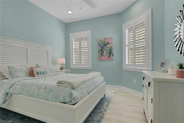 Bedroom with light wood-style floors, a ceiling fan, and recessed lighting