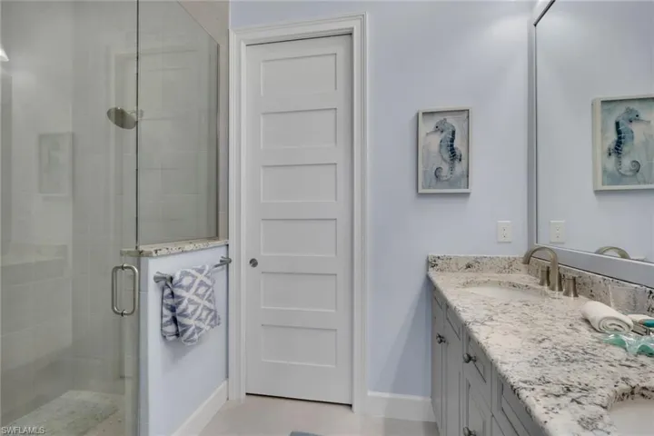Full bath with a shower stall and double vanity