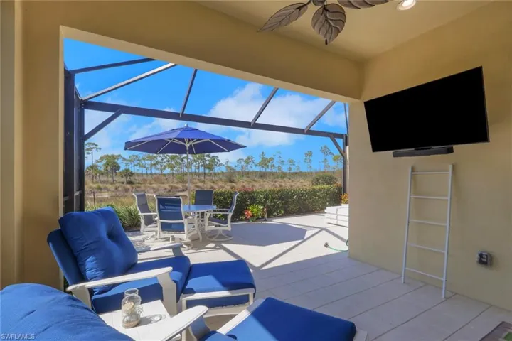 View of patio / terrace featuring a sunroom, a lanai, an outdoor living / dining area, and a ceiling fan