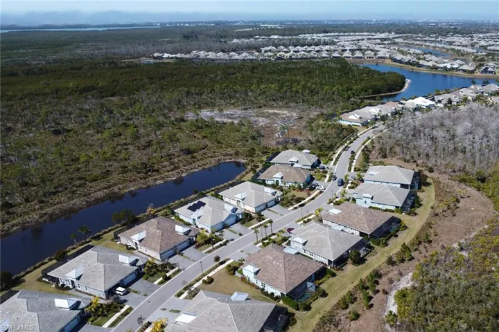 Aerial overview of property's location with nearby suburban area and a nearby body of water