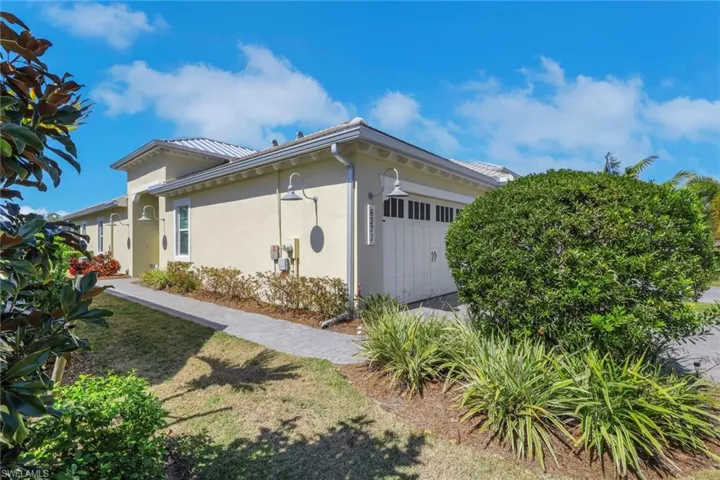 View of side of home with stucco siding and a garage