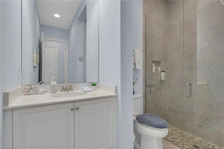 Bathroom featuring vanity and a shower stall