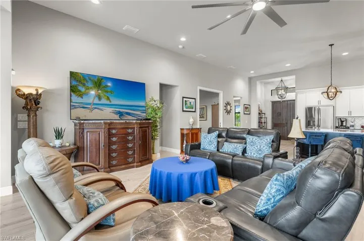 Living room with light wood finished floors, recessed lighting, and ceiling fan