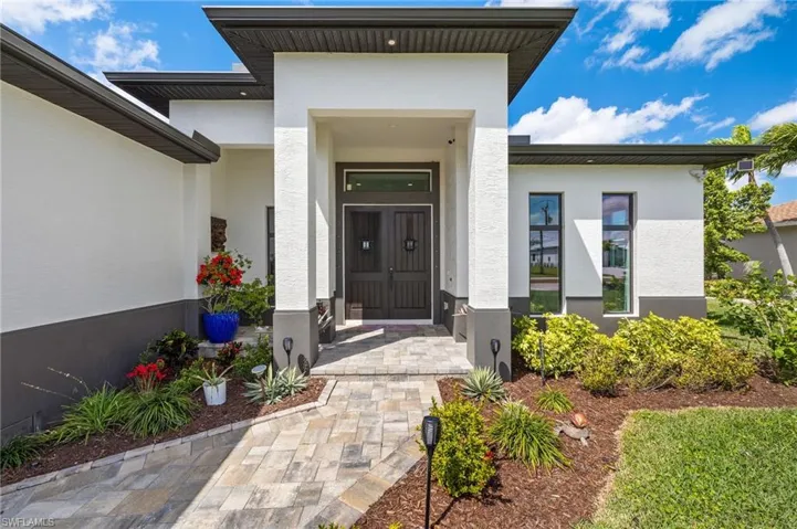 Entrance to property with stucco siding