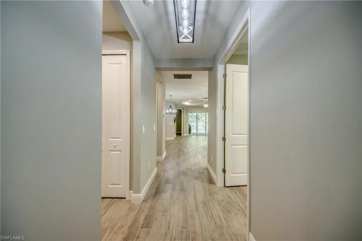 Wide entry hallway with a modern style ceiling light fixture provides plenty of light