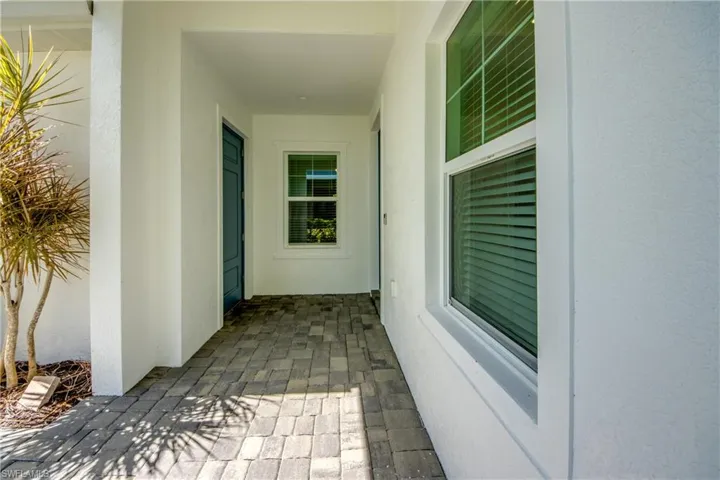 Covered private entry with a porch like feel and space for furniture