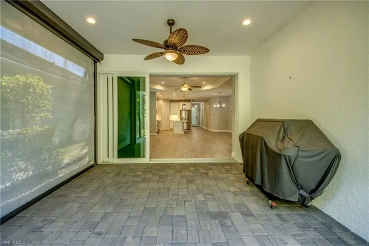 Covered patio featuring an outdoor ceiling fan, recessed lighting, pavers and natural gas grill