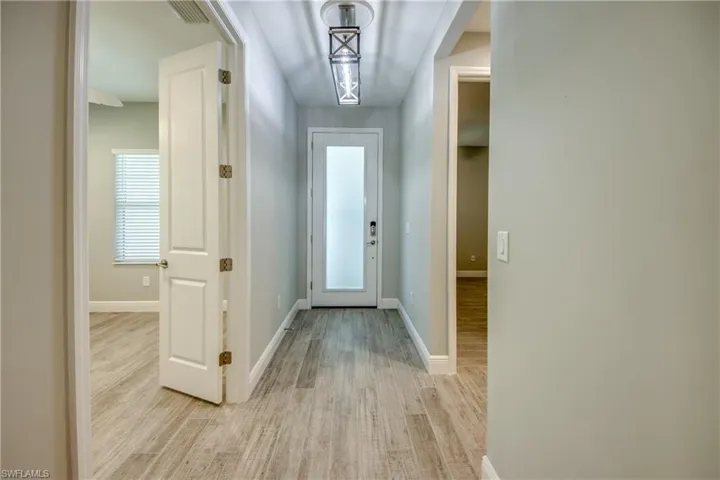 Impact entry door with glass allows light in the foyer but also with privacy
