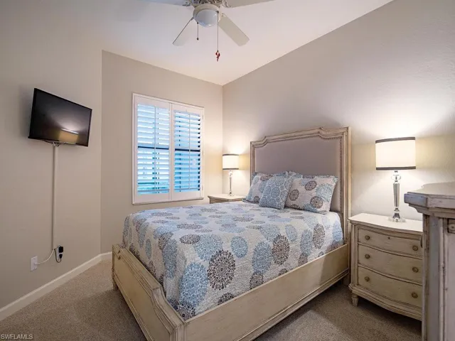 Carpeted bedroom with ceiling fan