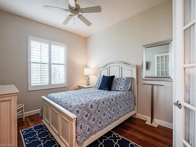 Bedroom featuring ceiling fan and dark wood-type flooring