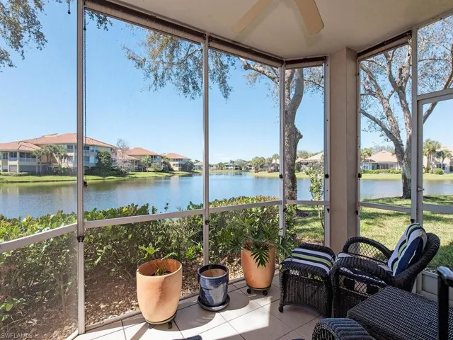 Sunroom / solarium with ceiling fan, a water view, and a wealth of natural light