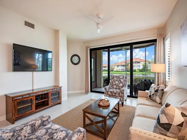 Living room featuring ceiling fan and light tile patterned floors