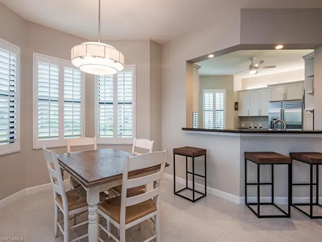 Tiled dining space with ceiling fan