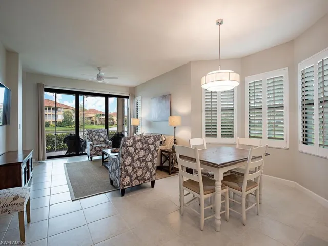 Tiled dining room featuring ceiling fan