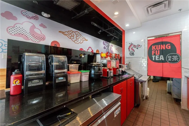 Kitchen featuring tile patterned flooring and tile walls