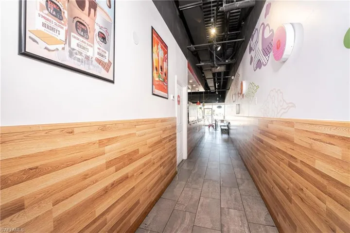 Hall featuring wooden walls