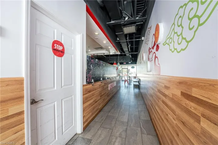 Hall with hardwood / wood-style flooring