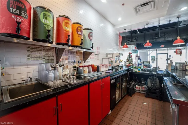 Kitchen featuring dark tile patterned floors and sink