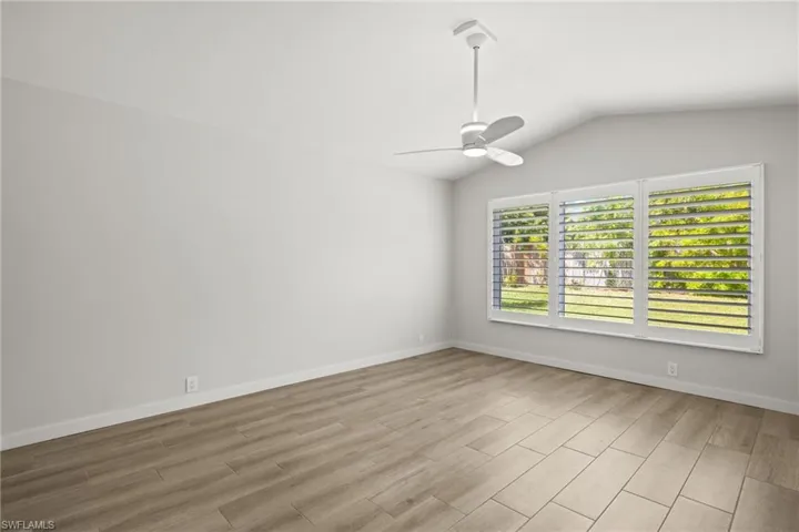Large Primary Bedroom  featuring vaulted ceiling, light hardwood / wood-style floors, and ceiling fan