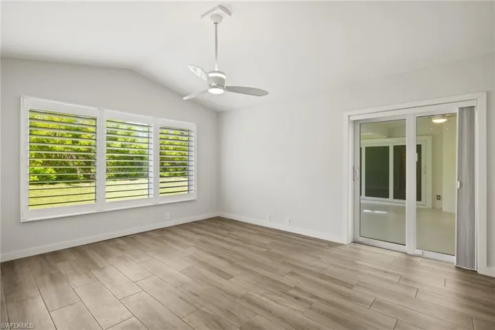 Large Primary Bedroom  featuring vaulted ceiling, light hardwood / wood-style floors, and ceiling fan