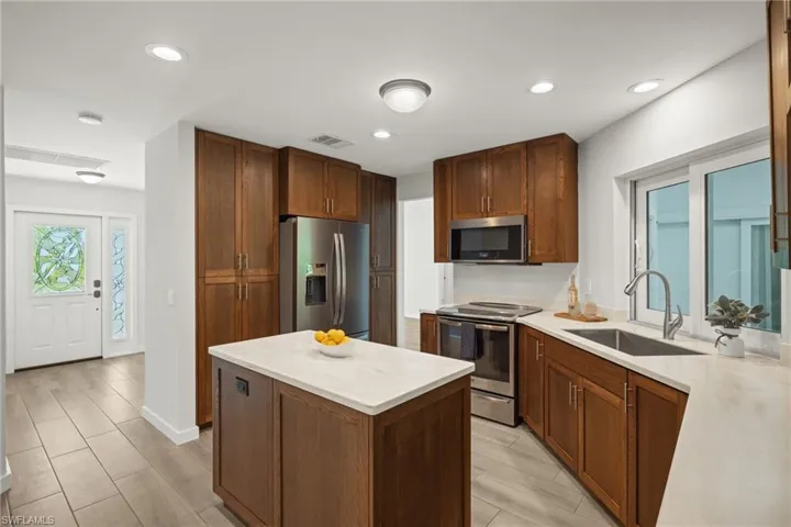 Kitchen featuring appliances with stainless steel finishes, sink, and light hardwood / wood-style flooring