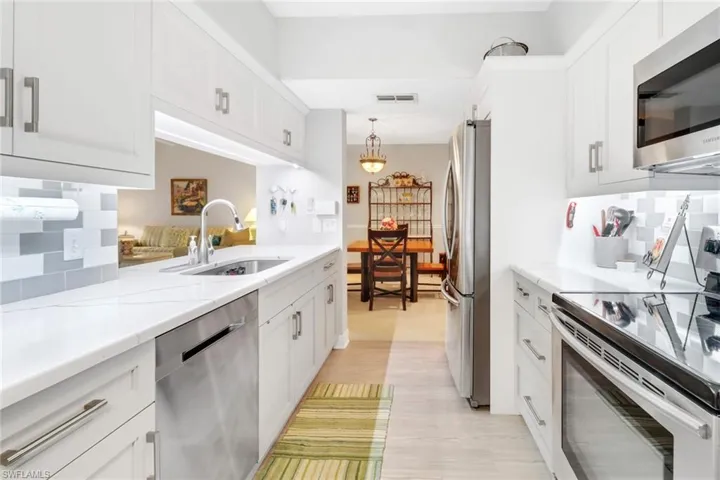 Kitchen featuring white cabinets, appliances with stainless steel finishes