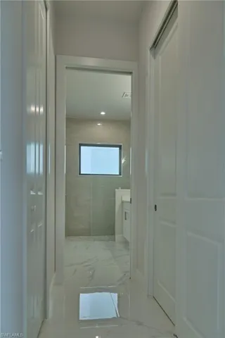 Hallway featuring tile floors
