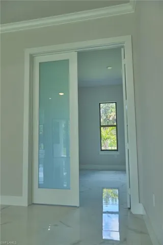 Spare room with crown molding and tile flooring