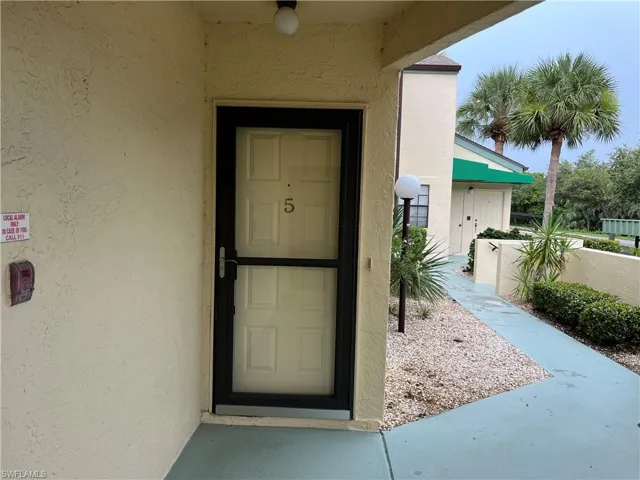 Entrance to property featuring stucco siding