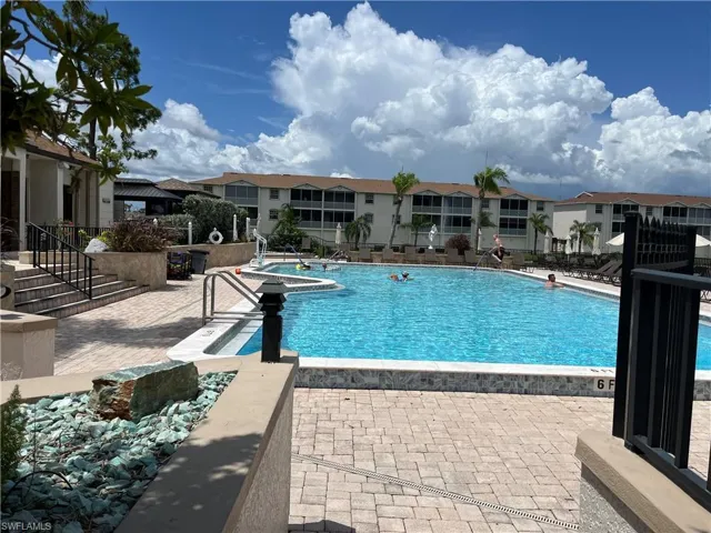Community pool featuring a patio and a residential view