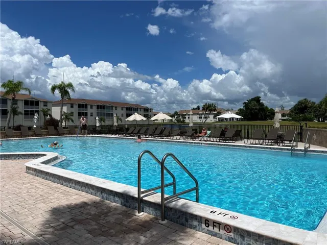 Community pool with a patio