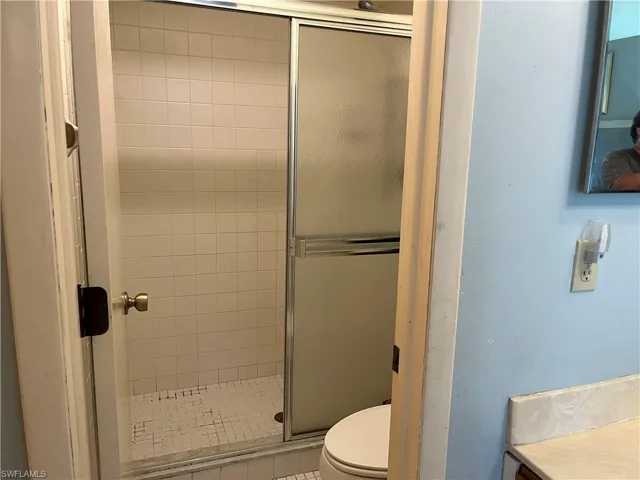 Full bathroom with a shower stall and vanity