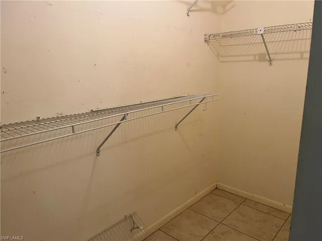 Spacious closet featuring light tile patterned flooring