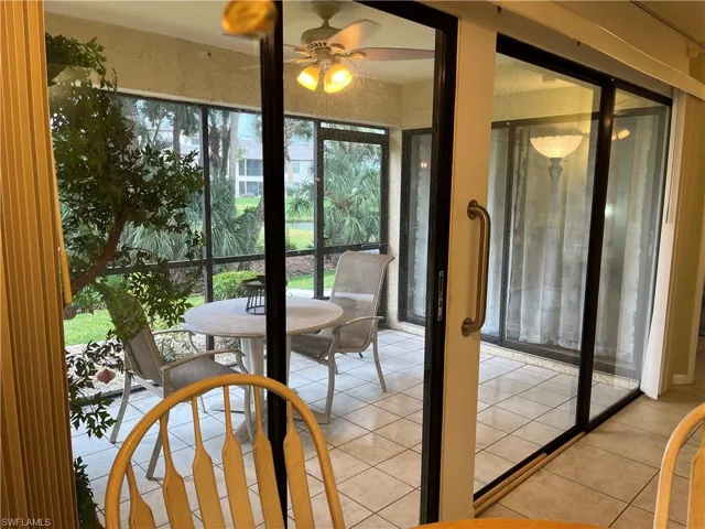 Sunroom with healthy amount of natural light and tile patterned floors