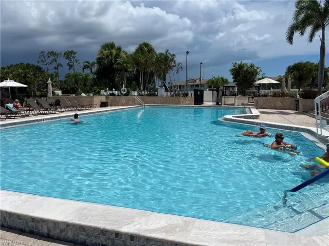 Community pool with a patio