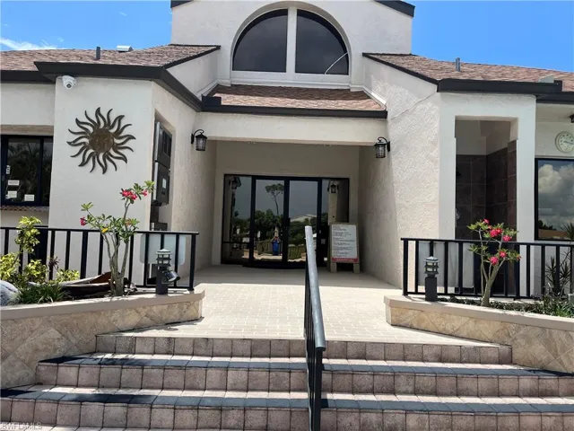 Doorway to property featuring stucco siding
