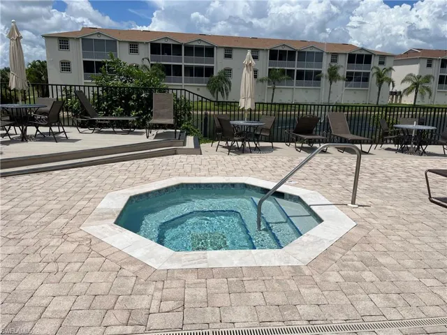 View of swimming pool with a community hot tub, a patio, and outdoor dining space