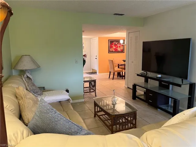Tiled living area with a textured ceiling