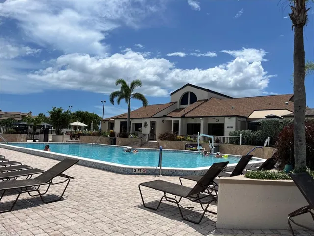 Community pool with a patio