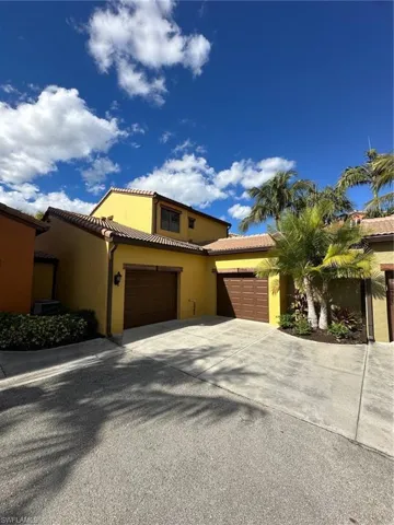 Mediterranean / spanish house with driveway, stucco siding, and a tile roof