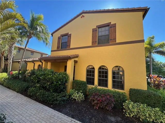 View of property exterior featuring stucco siding and a tile roof