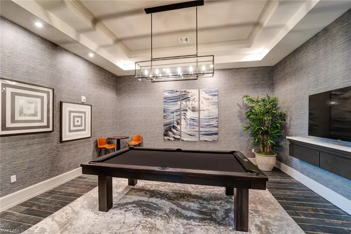 Game room featuring crown molding, billiards, and a tray ceiling