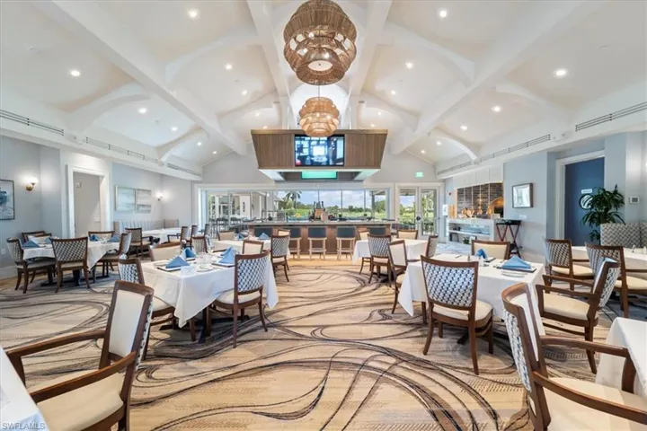 Dining area with high vaulted ceiling, beamed ceiling, and recessed lighting