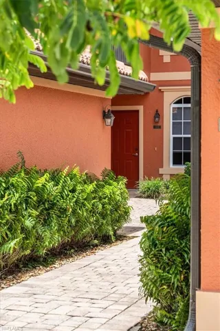 Doorway to property featuring stucco siding