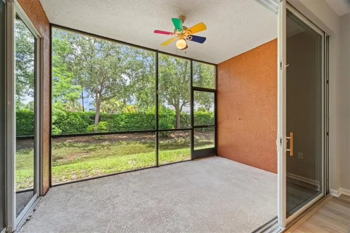Unfurnished sunroom with ceiling fan and plenty of natural light