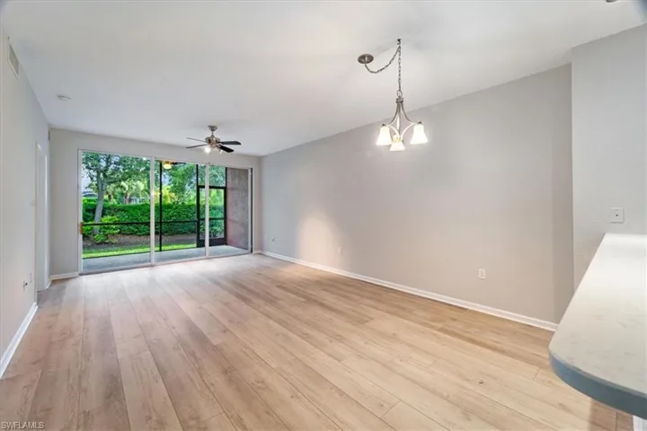 Empty room with light wood-style flooring and ceiling fan