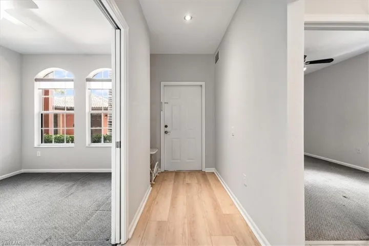 Hallway featuring wood finished floors and recessed lighting