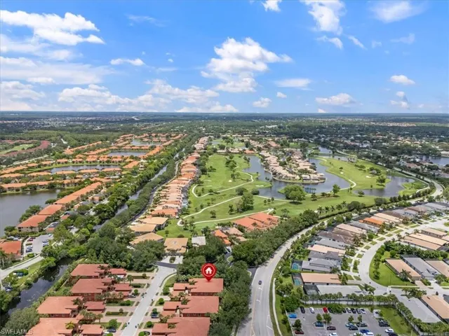 Aerial perspective of suburban area featuring a nearby body of water
